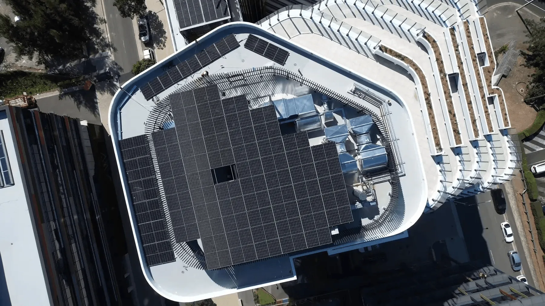 Aerial view of the solar array on the roof of a high-rise at Sydney Olympic Park.
